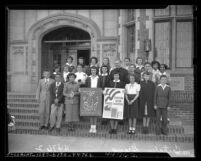 Catholic school students with signs reading "Let's cooperate to keep this nation under God" and "Christian nation through education" in Los Angeles, Calif., 1949