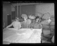 Two women in masks making mattresses as another looks on in California State Emergency Relief Administration program, 1935