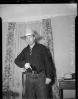 Dr. Ralph Wagner poses with a gun and hat, Los Angeles, 1930s