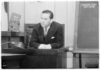 Actor Ben Lyon on the witness stand during a trial for Albert F. Holland, who wrote 150 love letters to Lyon's wife, actress Bebe Daniels, Los Angeles, 1933