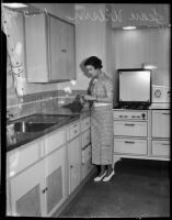 Jean Wilson cooks in kitchen, Los Angeles, 1930s