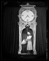 Model Tilli Dieterle making entrance under clock during California Fashion Show in Los Angeles, Calif., 1947