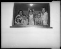 Mrs. Fleeta Gettle and her children smile for the camera, after the safe return of kidnapping victim William F. Gettle. Circa May 15, 1934