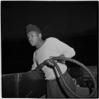 Sailor holding a rope during the Army-Navy maneuvers off the coast of Southern California in late 1946