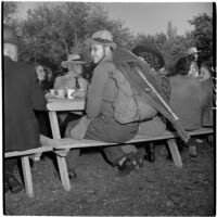 W.J. Stowe sitting at a picnic table during Anaheim's annual Halloween festival, Anaheim, October 31, 1946