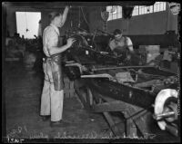 Men at work at the Los Angeles Studebaker assembly plant in Vernon, CA. Circa January 2, 1936