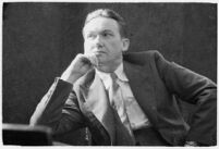 Widower Robert S. James sitting in a courtroom during an inquest involving his wife's death, Los Angeles, 1935