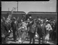 Prince and Princess Kaya of Japan are escorted through a crowd at La Grande Station by Mayor Frank Shaw, Los Angeles, 1934