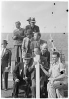 Sports officials keeping time at a track meet between UCLA and USC, Los Angeles, 1937