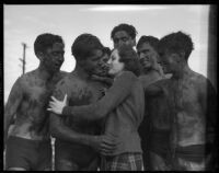 LAJC students gather around unidentified woman after a mud fight, Los Angeles, 1930s