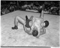 Heavyweight wrestler Vincent López puts his opponent in a headlock, Los Angeles, 1930s