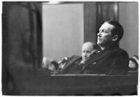 Widower Robert S. James sitting in a courtroom during an inquest involving his wife's death, Los Angeles, 1935