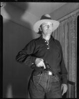 Dr. Ralph Wagner poses with a gun and hat, Los Angeles, 1930s