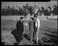 Coach Thomas and Mildred Cowan on football field with Alabama Crimson Tide players Bill Lee and Dixie Howell, Tuscaloosa, 1934-1935