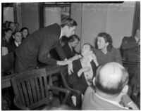 Charles Hardaker comforts his wife Betty Hardaker during her trial for the murder of their daughter, Los Angeles, 1940