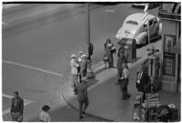 Aerial view of pedestrians and Owl Drug on the corner of Hollywood and Vine, Los Angeles, 1940