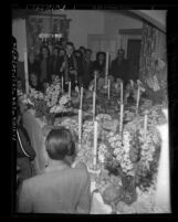 Father Robert Deegan blessing table of food on St. Joseph's Day in Los Angeles, Calif., 1948