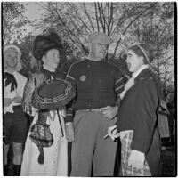 Anaheim mayor Charles A. Pearson and his wife Sarah Fay Pearson talking to a clown at Anaheim's annual Halloween festival, Anaheim, October 31, 1946