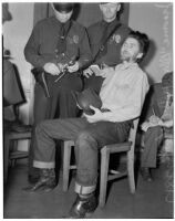 Cowboy film extra Jerome "Blackjack" Ward talks to police during a re-enactment of his confrontation with fellow extra Johnny Tyke, Los Angeles, February 24, 1940