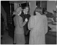 Three women shopping for hats during the semiannual Dollar Day sale in downtown Los Angeles, February 17, 1940