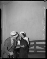 Ann Forst sits with an unidentified man at the county jail after being charged with operating a prostitution ring, Los Angeles, 1940