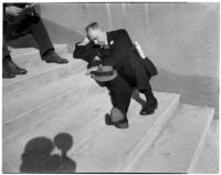 Spectator taking a break between races at Santa Anita Park, Arcadia, March 2, 1940