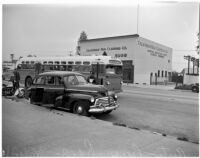 Automobile and bus that competed in a planned race to demonstrate the importance of following traffic laws, Los Angeles, 1947