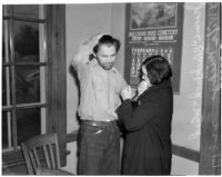 Cowboy film extra Jerome "Blackjack" Ward with his wife Mickey during a re-enactment of his confrontation with fellow extra Johnny Tyke, Los Angeles, February 24, 1940