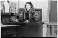 Actress Bebe Daniels on the witness stand during a trial for Albert F. Holland, who wrote 150 love letters to Daniels, Los Angeles, 1933