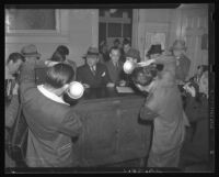 William Bioff (center) being photographed by news photographers, 1939