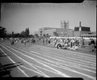 Track athletes race during the All-City High School track and field meet, Los Angeles, 1937