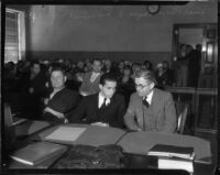 Louis Payne sits with father, Lucius F. Payne, in a courtroom, Los Angeles, June-July, 1934