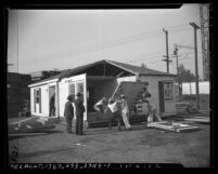 Workers constructing prefabricated house made by Hamill and Jones Lumber Company in Los Angeles, Calif., 1946