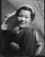 Miss Lil Tokio Alice Watanabe poses with a fan in a traditional kimono in honor of the Nsei festival, Los Angeles, 1935