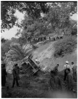 Fire fighting crew in La Canada surveying damage from a brush fire, Los Angeles, October 1945