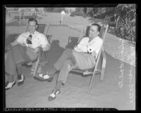 J. Edgar Hoover and his assistant Clyde Tolson sitting in beach lounge chairs, circa 1939