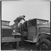 Man checks out a truck at the War Assets Administration's surplus sale, Port Hueneme, May 1946