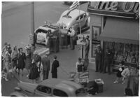 Aerial view of pedestrians and Owl Drug on the corner of Hollywood and Vine, Los Angeles, 1940