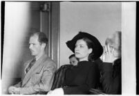 Private detective Pearl Antibus shields her face as she appears in court with her daughter Norma Thelan during her trial against millionaire Thomas W. Warner, Sr, Los Angeles, 1938