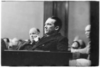 Widower Robert S. James sitting in a courtroom during an inquest involving his wife's death, Los Angeles, 1935