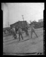 Cole Brothers Circus workers pounding in stakes for tent in Los Angeles, Calif