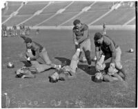 Washington Huskies stretch before a game against the UCLA Bruins at the Coliseum, Los Angeles, 1936