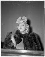 Mae West sitting in court during questioning about earnings from her role in the movie "She Done Him Wrong," Los Angeles, 1940