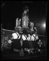 Girls praying before "Our Lady of the Cape of the Holy Rosary" statue on loan from Quebec to St. Joseph's Catholic Church in Los Angeles, Calif., 1947