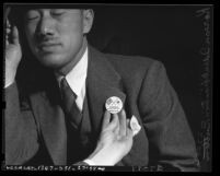 Korean American man wearing button stating "Korea for victory with U.S." in 1941, Los Angeles, Calif