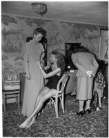 Models helping each other get ready in the dressing room before a fashion show, Los Angeles