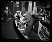 Kenneth Hahn, Los Angeles City Councilman inspecting bar at nightclub in Los Angeles, Calif., circa 1948