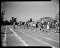 Track athletes pass batons in a relay event during the All-City High School track and field meet, Los Angeles, 1937