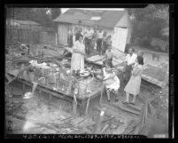 Myrlene Oldacre and family standing in rubble of house that her landlady tore down in order to evict her Los Angeles, Calif., circa 1948