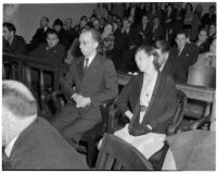 Betty Hardaker, mother convicted of murdering her daughter, sits with her brother Samuel Karnes, Jr. in a courtroom, Los Angeles, 1940